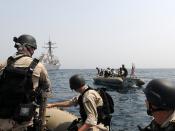Members of the visit, board, search and seizure team from USS Truxtun ride in rigid hull inflatable boats