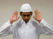 English: A Muslim raises his hands in Takbir, marking the beginning of his prayers