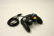 English: black nintendo game cube кг:Чёрный контроллер Nintendo GameCube.