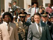English: Secretary of Defense Caspar W. Weinberger hosts Armed Forces Full Honors Arrival Ceremony for His Excellency, Commander in Chief Samuel Kanyon Doe (L, tan suite), Head of State of the Republic of LIBERIA outside the Pentagon's River entrance. Loc
