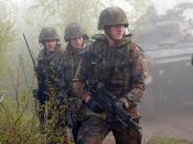 English: During exercise Joint Resolve 26, in Bosnia and Herzegovina (BiH), soldiers from the German Battle Group's 2nd Reinforced Infantry Company, armed with Heckler and Koch automatic assault rifles, seek to capture French soldiers playing the role of 