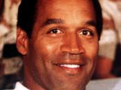 NBC Sports commentator and former professional football player O. J. Simpson sits with a group of servicemen to watch a Thanksgiving Day football game. Simpson is visiting U.S. troops who are in the region for Operation Desert Shield.