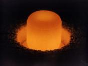 A pellet of plutonium-238, glowing under its own light, used for radioisotope thermoelectric generators.