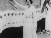 English: Alice Paul, full-length portrait, standing, facing left, raising glass with right hand.