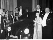 German Press Ball 1939. Dr. Ferdinand Porsche presents the Volkswagen tombola prize to Mrs. Elsa Ellinghausen, the lucky winner.