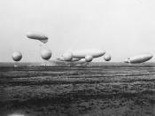 U.S. Navy blimps at the Naval Air Station in Lakehurst, New Jersey (USA), during what appears to be a demonstration, in 1930-1931. Among the craft present are a kite balloon (upper craft at left), five free balloons, the USS Los Angeles (ZR-3) in the midd