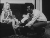 Actor Duane Jones as Ben gives actress Judith O'Dea, playing Barbra, her slippers in a scene from the movie Night of the Living Dead