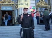 English: A man in black traditional Christian garb stands on the steps of San Francisco city hall with a sign that reads 