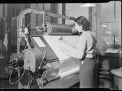 Examining and picking. The fabric is rolled from the lower beam over this board and on to the beam in front of the operator, 1936