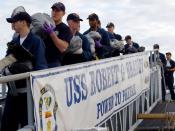 English: Mayport, Fla. (Jan. 12, 2007) - Sailors aboard the guided missile frigate USS Robert G. Bradley (FFG 49) offload 23 tons of illegal drugs seized in a multi-national and interagency effort to interdict the flow of narcotics into the United States.