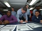 US Navy 031214-N-1045B-001 USS George Washington (CVN 73), Commanding Officer, Capt. Martin J. Erdossy, enjoys seeing Airman Craig Land, from Saucier, Miss., sign a