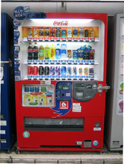 English: Soft drink vending machine in Japan. It is Soft drinks made by Coca-Cola that it is sold, there are coke and coffee from 500ml to 190ml. 日本語: 日本にある清涼飲料水の自動販売機。