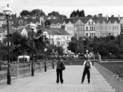 English: Rollerblading by Bangor marina Two 'rollerbladers' make their way along the path by Bangor marina (unseen, to right). Houses at Mount Royal, Mount Pleasant and the Princetown Road are beyond.