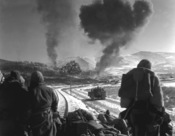 Original caption: CLOSE SUPPORT-- This is one of a series of three remarkable combat photographs showing the close coordination of the United States Marine air and ground units during recent fighting with Chinese Communists in Korea. United States Marines