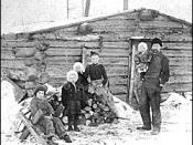 English: Minnesota family poses in front of log cabin, 1890
