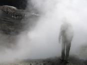 Man walking into the mist, within the crater of Whakaari/White Island.
