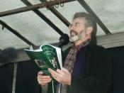 Gerry Adams at the Fermanagh Commemoration, reading aloud into a microphone.