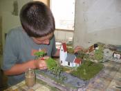 A child finishing a scale model during an initiation week