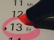 Circling Friday the 13th date on calendar with marker