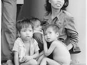 English: South China Sea....A refugee woman cares for three small children on the replenishment oiler USS Wabash, AOR-5. Twenty-eight boat people were picked up from their wooden boat by a whaleboat from the oiler., 08/05/1979
