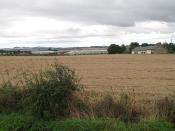 English: North Elphinstone Wheat field and houses with the research facility in the background. I always expect to get my collar felt photographing around here, given the massive clampdown on animal rights activists. Time to turn right and head off to Fal
