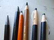 2 woodless graphite pencils in plastic sheaths, 2 charcoal pencils in wooden sheaths, 2 charcoal pencils in paper sheaths that is unwrapped as the pencil is used.