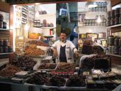 Date seller in the old souq in Kuwait City, surrounded by dates from Kuwait, Iran, Saudi Arabia and elsewhere.