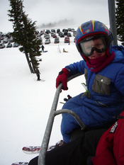 Chair lift restraining bar holding a happy 6-year-old passenger. This is the Bruno lift at Timberline Lodge ski area