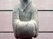 A Chinese Han Dynasty (202 BC - 220 AD) ceramic figurine of a lady servant with hands placed in front and covered in long silk sleeves.