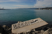 Wellington Harbour with foreground artwork showing an excerpt from Denis Glover's poem 'Wellington Harbour is a Laundry'