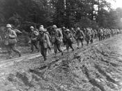 The 442nd Regimental Combat Team, hiking up a muddy French road in the Chambois Sector, France, in late 1944.