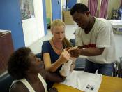 Occupational Therapist Melanie Glapa works with student George Hage to assist hand therapy patient ‘Pemoli’ at the physiotherapy ward at the National Referral Hospital, Honiara.