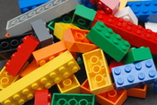 A pile of Lego blocks, of assorted colours and sizes.