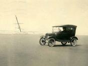 Automobile on a Pacific beach with shipwreck in background