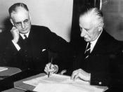 English: Governer General of Australia Lord Gowrie signing the declaration of war against Japan with Prime Minister John Curtin looking on. (World War Two)