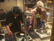 DJ Hypnotize and Baby Cee DJ'ing Flckr By-sa image