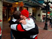 An emotional man grabs his friend in a burst of happiness in Gastown in Vancouver. People took to the streets to celebrate Canada's gold medal victory in Hockey over the United States.