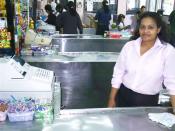 A cashier at her register in a grocery store in Panama.