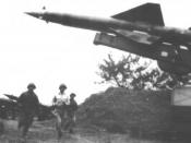 English: North Vietnamese personnel scramble to ready an SA-2 missile to engage American aircraft.