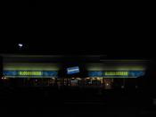 A Blockbuster movie rental store on FM 1960 Houston, Texas at night.