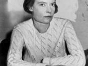 Dorothy Day half-length portrait, seated at desk, facing right