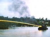 A U.S. riverboat (Zippo monitor) deploying napalm during the Vietnam War