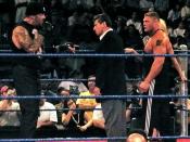 English: From left-to-right: Undertaker (real name Mark Calaway), Vince McMahon, Brock Lesnar and Sable (hidden behind Brock, the blond hair is hers).