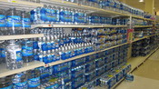 English: Bottled water fills an aisle in a supermarket