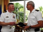 US Navy 090527-N-4047W-264 Cmdr. John Wade, commanding officer of the guided-missile destroyer USS Preble (DDG 88), left, exchanges gifts with Rear Adm. Jean Louis Vichot