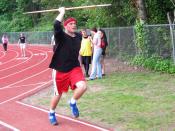 A high school athlete throwing the javelin.