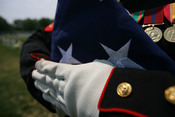 English: A folded American flag held by a United States Marine at the funeral of Douglas A. Zembiec.