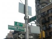 English: Looking east and up at street sign for Katharine Hepburn Way on a cloudy day.