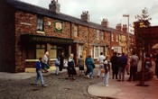 Tourists are show round the set of the ITV soap opera Coronation Street, viewing the Rovers Return Inn at Granada Studios, Manchester, England.