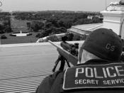 Secret Service agents positioned atop the roof of the White House.